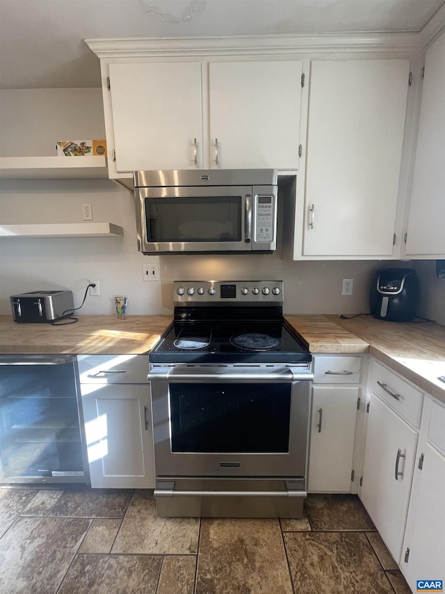 3133 Burnley Station Rd, Barboursville, VA 22923 - kitchen with appliances with stainless steel finishes, stone tile flooring, light countertops, and white cabinets
