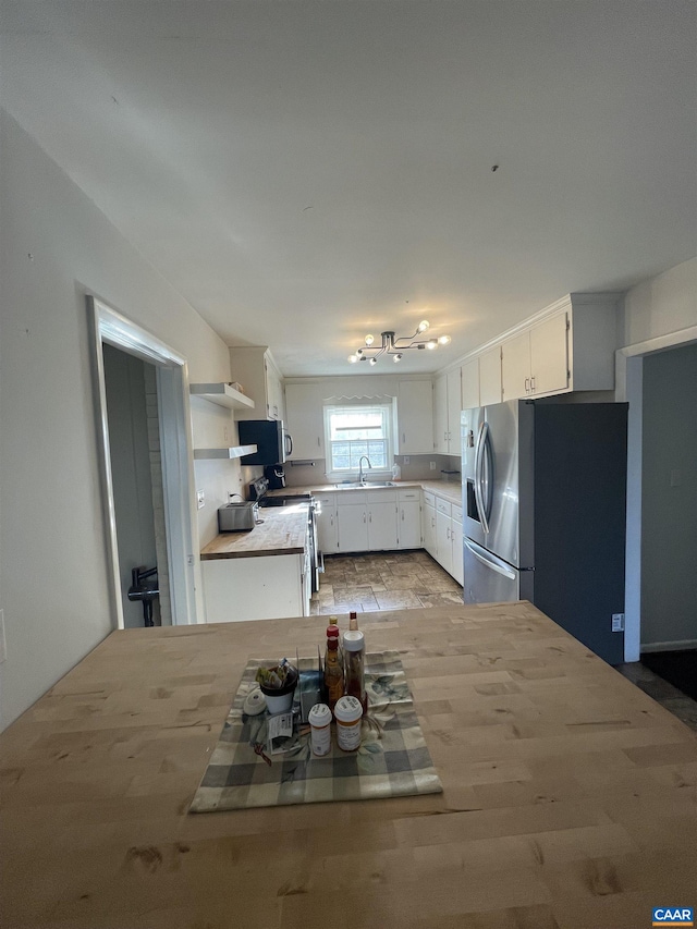3133 Burnley Station Rd, Barboursville, VA 22923 - kitchen featuring appliances with stainless steel finishes, white cabinetry, open shelves, a sink, and light countertops