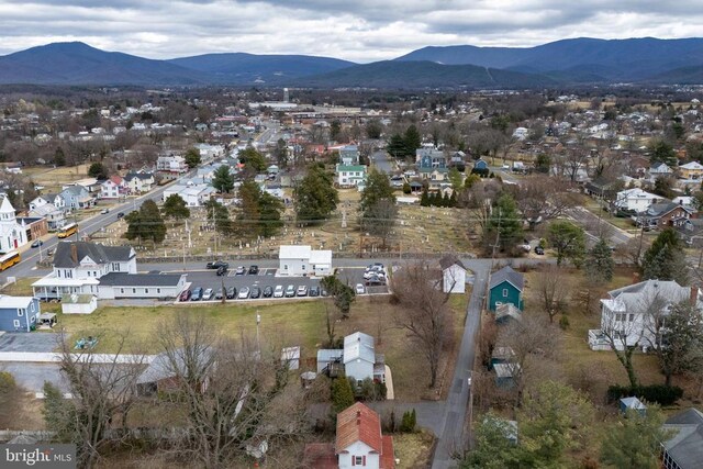 aerial overview of property's location with a mountainous background and nearby suburban area