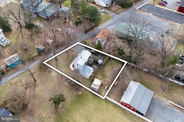 aerial view of property and surrounding area featuring property parcel outlined
