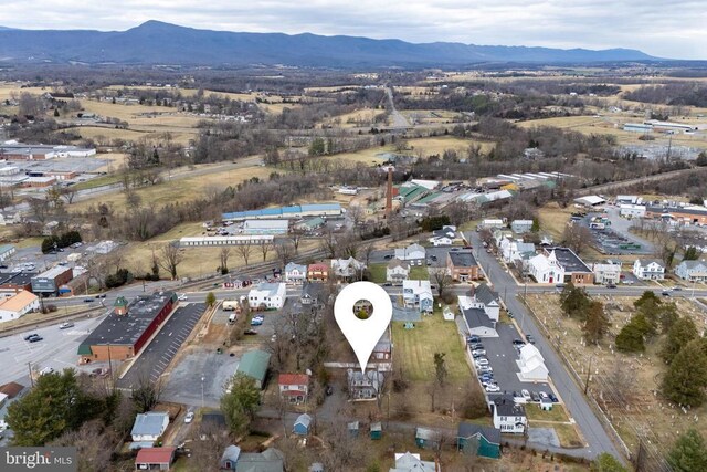 aerial view of property's location featuring a mountainous background