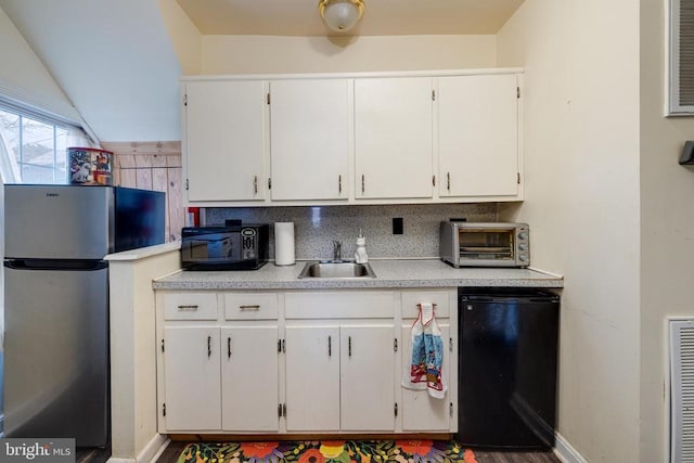 115 Page St E, Luray, VA 22835 - kitchen featuring freestanding refrigerator, black microwave, light countertops, refrigerator, and white cabinetry