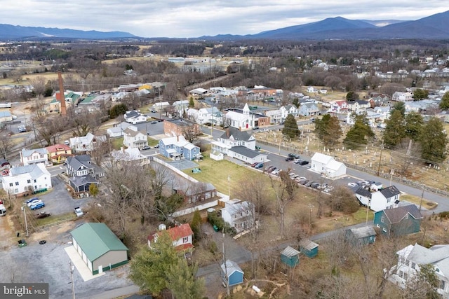 aerial overview of property's location featuring a mountain backdrop and nearby suburban area