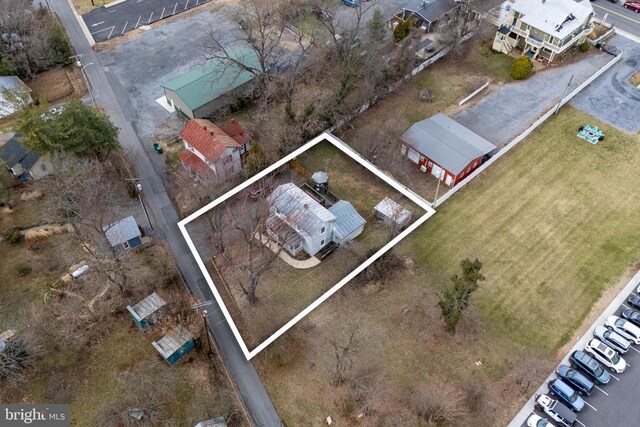 aerial view of property and surrounding area featuring property parcel outlined