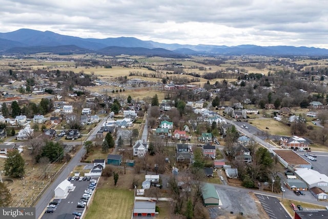 aerial view of property and surrounding area with a mountain backdrop