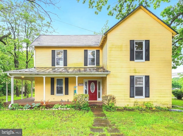 100 Marshall St E, Remington, VA 22734 - view of front of home featuring a standing seam roof, covered porch, a front lawn, and metal roof