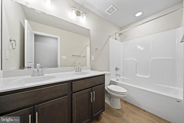 150 Holly Ct, Mineral, VA 23117 - bathroom with toilet, wood finished floors, double vanity, and bathtub / shower combination