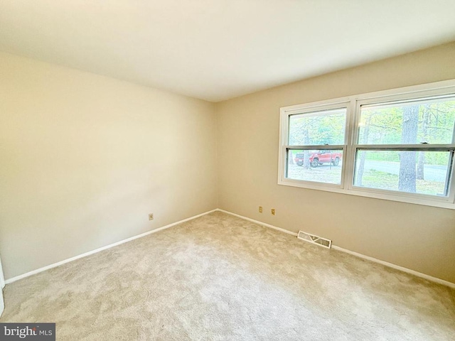 carpeted spare room with baseboards