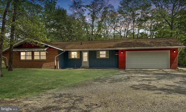 201 Hardwood Ln, Fredericksburg, VA 22408 - view of front of property featuring board and batten siding, gravel driveway, a garage, and a front lawn