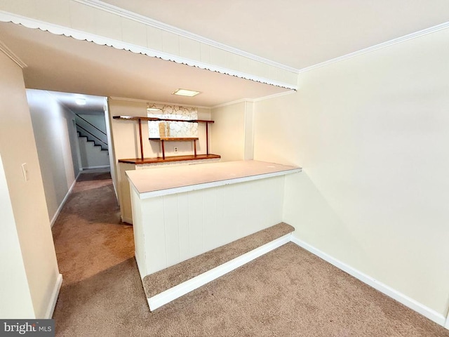 kitchen with carpet floors, baseboards, crown molding, a peninsula, and light countertops