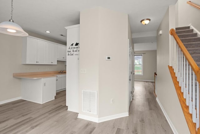 2890 Crystal Spring Ln, Rockingham, VA 22801 - kitchen with light wood-style floors, white cabinetry, light countertops, recessed lighting, and baseboards