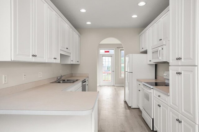 2890 Crystal Spring Ln, Rockingham, VA 22801 - kitchen with white appliances, a sink, arched walkways, recessed lighting, and light wood-type flooring