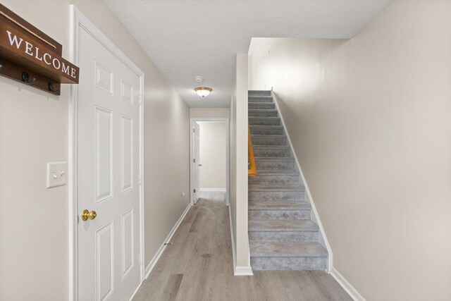 2890 Crystal Spring Ln, Rockingham, VA 22801 - stairway with wood finished floors, baseboards, and a textured ceiling