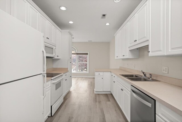 2890 Crystal Spring Ln, Rockingham, VA 22801 - kitchen with white appliances, a sink, white cabinets, recessed lighting, and light wood-style flooring