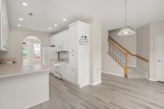 2890 Crystal Spring Ln, Rockingham, VA 22801 - kitchen featuring white appliances, arched walkways, light wood finished floors, light countertops, and recessed lighting