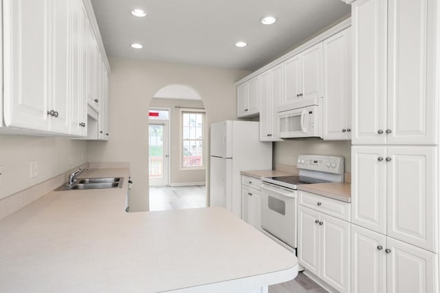 2890 Crystal Spring Ln, Rockingham, VA 22801 - kitchen featuring white appliances, a sink, arched walkways, recessed lighting, and white cabinetry