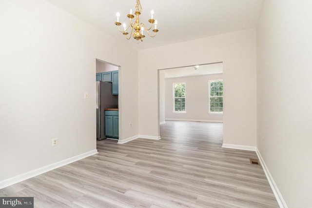 6224 Hot Spring Ln, Fredericksburg, VA 22407 - unfurnished dining area featuring a chandelier and light wood-style flooring