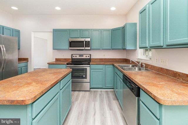 6224 Hot Spring Ln, Fredericksburg, VA 22407 - kitchen featuring stainless steel appliances, a center island, recessed lighting, light wood-style flooring, and blue cabinetry
