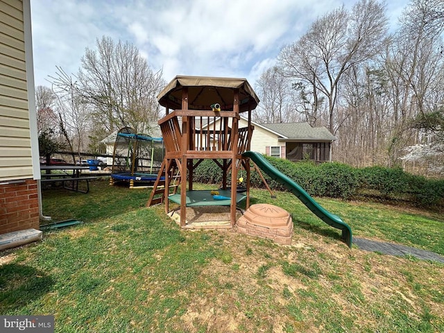 view of playground with a lawn