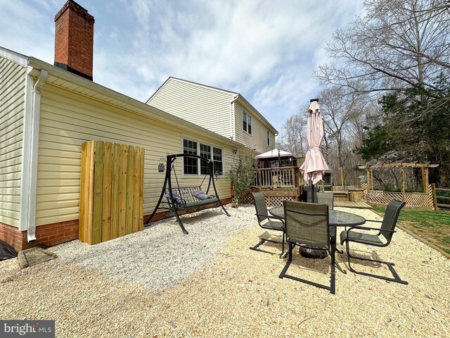 view of patio / terrace featuring outdoor dining area and a wooden deck