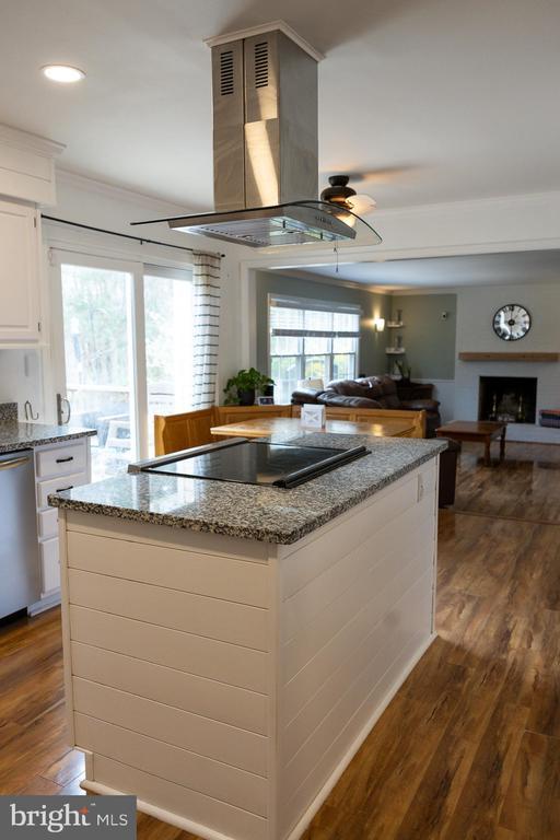 kitchen with black electric cooktop, dishwasher, dark wood-style flooring, white cabinets, and light stone countertops