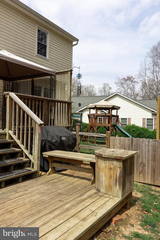 wooden terrace featuring fence and stairway