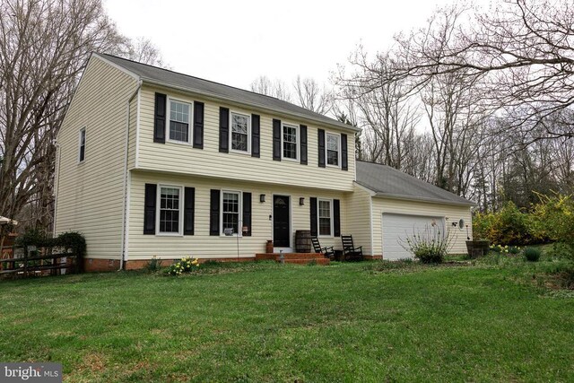colonial-style house featuring a garage and central AC unit