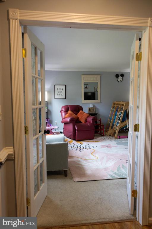 carpeted living area with french doors