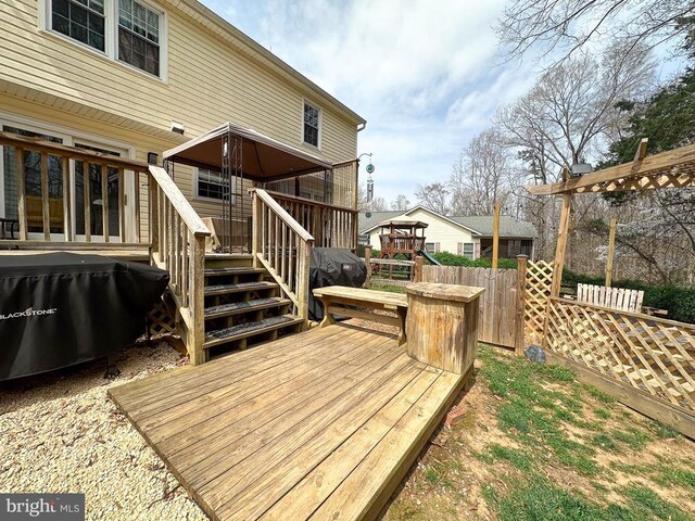 deck with fence and area for grilling