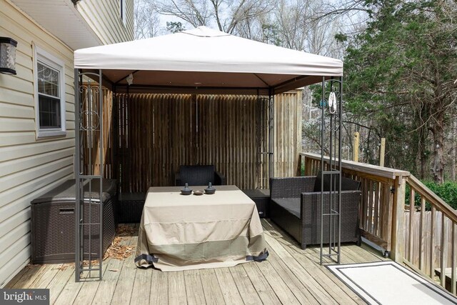 wooden terrace with a gazebo and central air condition unit