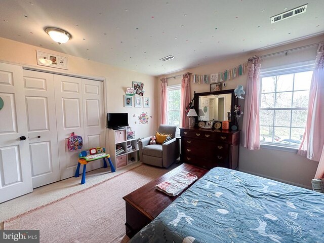 carpeted bedroom with a closet