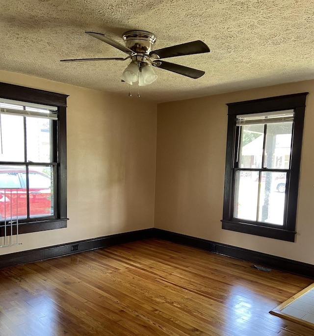 373 S Magnolia Ave S, Waynesboro, VA 22980 - unfurnished room featuring a textured ceiling, wood finished floors, and a healthy amount of sunlight