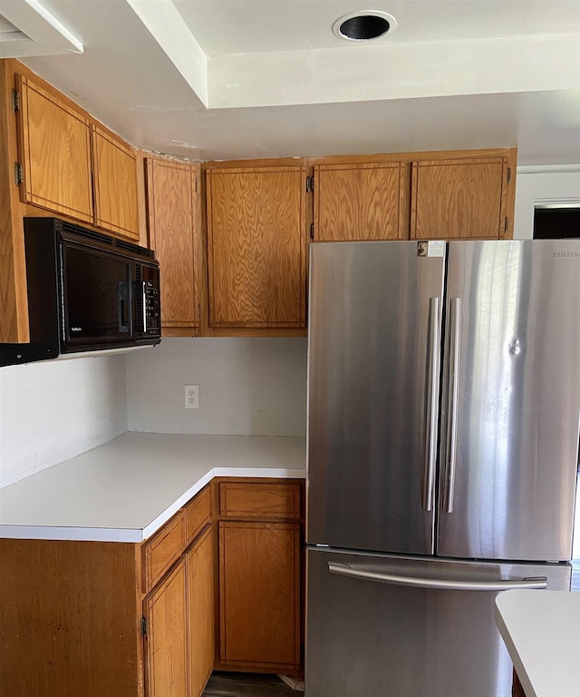 373 S Magnolia Ave S, Waynesboro, VA 22980 - kitchen with freestanding refrigerator, brown cabinets, black microwave, and light countertops