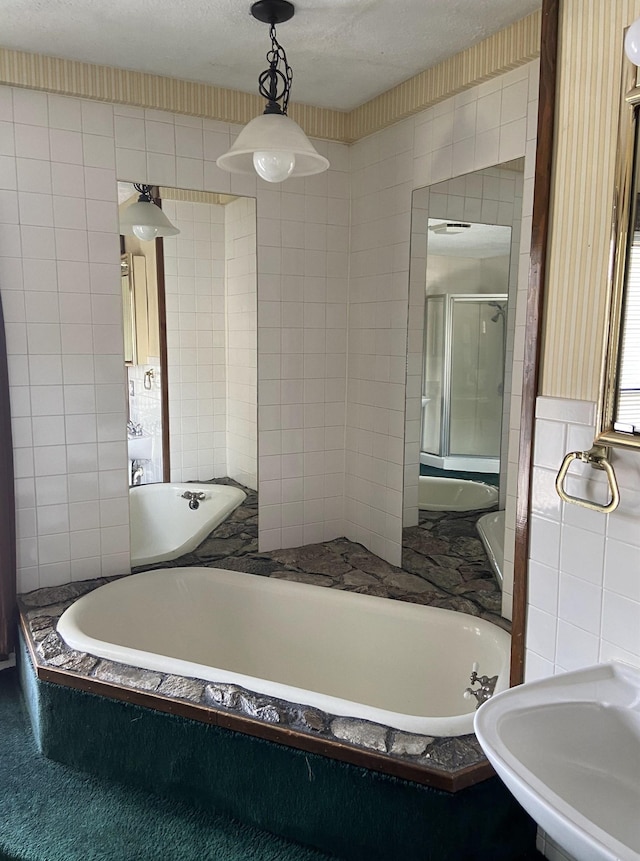 373 S Magnolia Ave S, Waynesboro, VA 22980 - bathroom with a shower stall, tile walls, a bath, and a sink