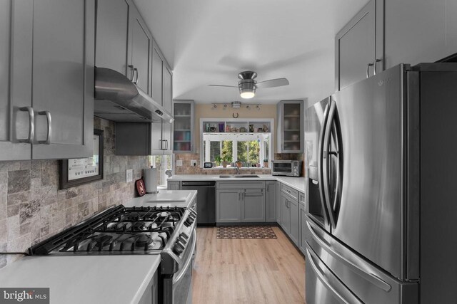 27478 Old Office Rd, Culpeper, VA 22701 - kitchen featuring stainless steel appliances, under cabinet range hood, gray cabinets, a ceiling fan, and decorative backsplash