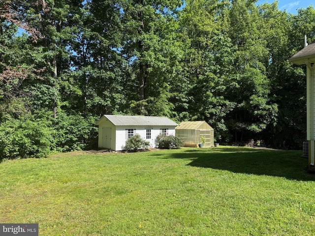 273 Pettit Pl, Louisa, VA 23093 - view of green lawn featuring a greenhouse and an outdoor structure