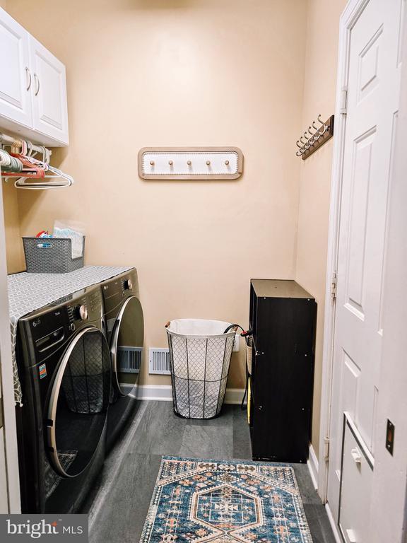  - laundry area featuring independent washer and dryer and cabinet space
