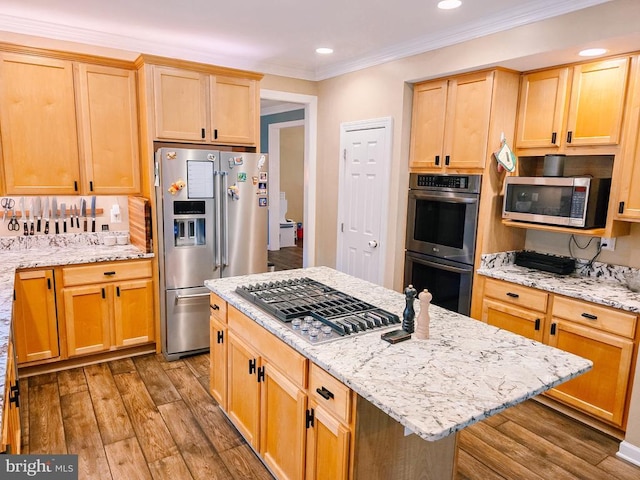  - kitchen featuring stainless steel appliances, wood finished floors, light brown cabinets, crown molding, and light stone countertops