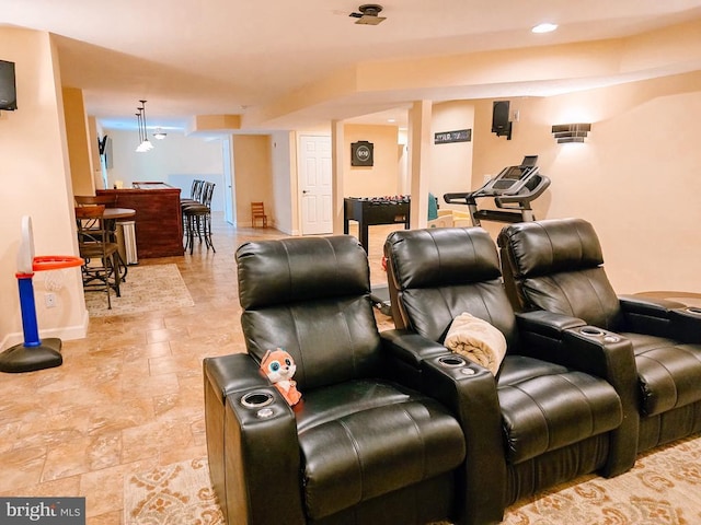  - home theater with light stone finish floors and baseboards