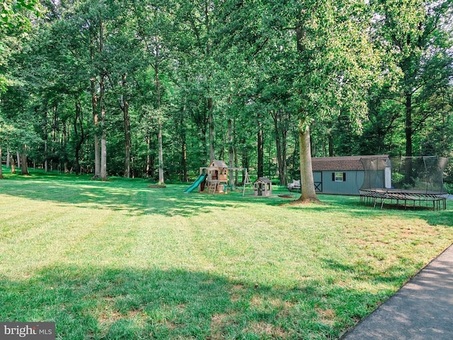  - view of green lawn featuring a trampoline and an outdoor structure