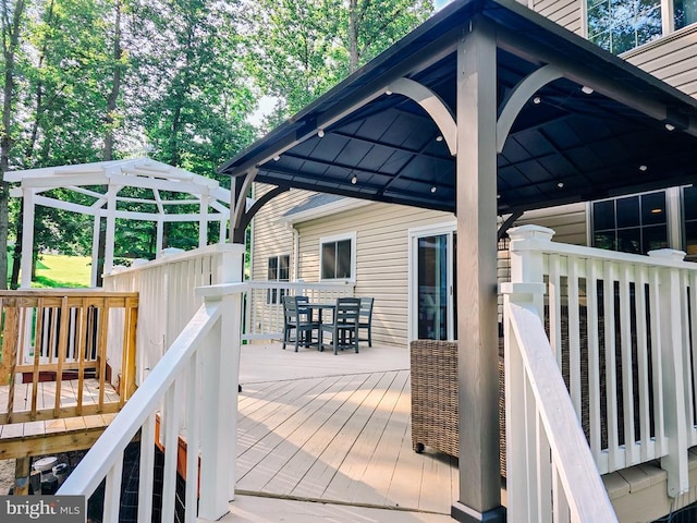  - wooden terrace with a gazebo and outdoor dining area