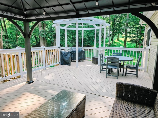  - deck featuring a gazebo, outdoor dining space, and area for grilling