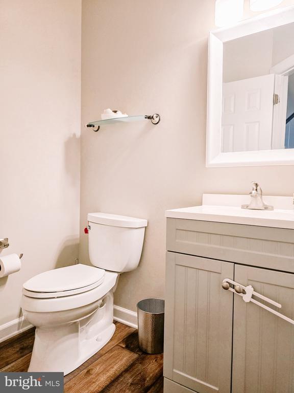  - bathroom featuring vanity and wood finished floors
