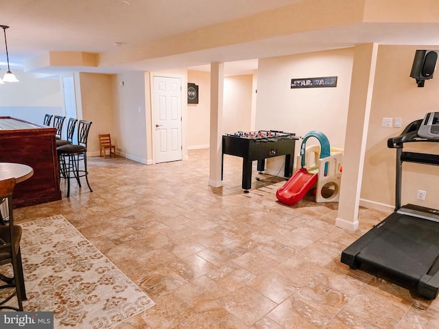  - recreation room with stone tile floors and baseboards