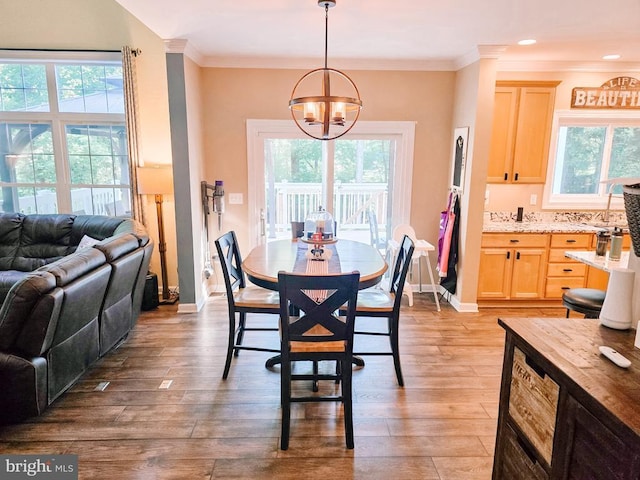  - dining space featuring a chandelier, healthy amount of natural light, ornamental molding, light wood finished floors, and recessed lighting