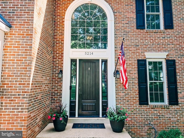  - doorway to property with brick siding