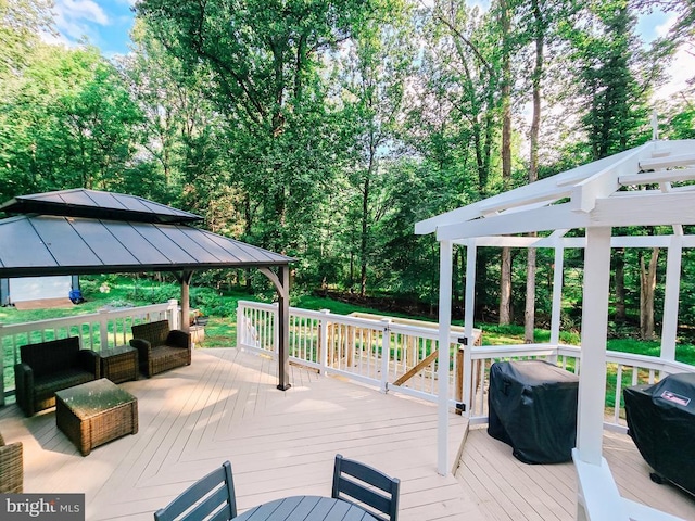  - wooden terrace with a gazebo, grilling area, and view of scattered trees