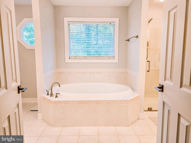  - bathroom with a bath, tile patterned floors, and a stall shower
