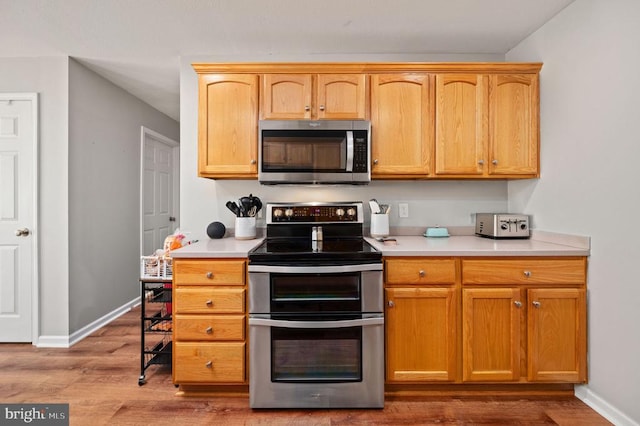 108 Shannon Glen Ct, Louisa, VA 23093 - kitchen with stainless steel appliances, wood finished floors, and light countertops