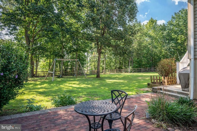 108 Shannon Glen Ct, Louisa, VA 23093 - fenced backyard featuring a patio and a playground